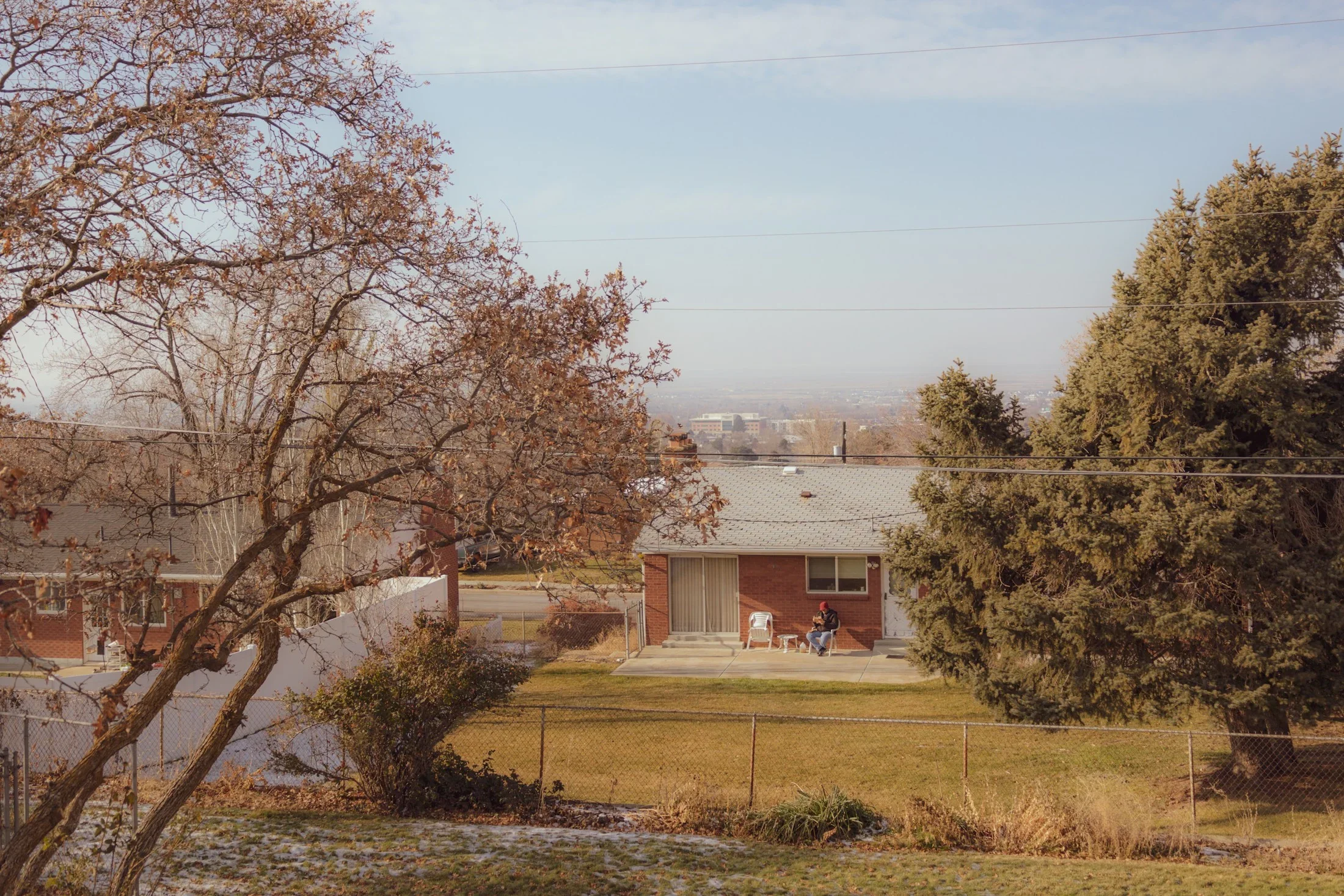 An established Bountiful home and lawn framed by mature trees